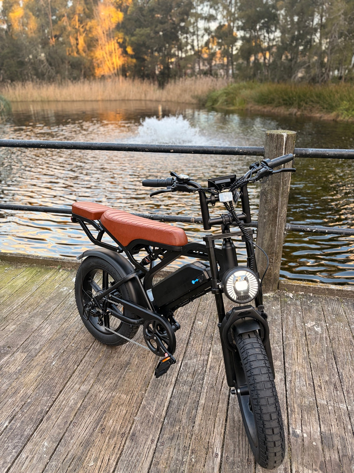 Evolve Horizon black e-bike front three-quarter view with headlight on